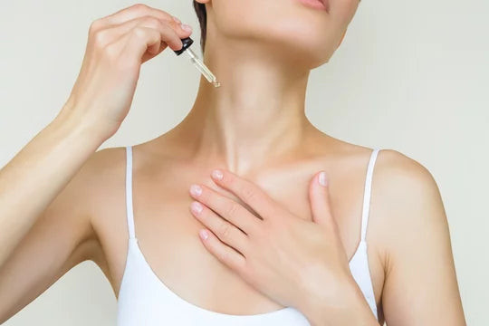 Woman applying neck Serum