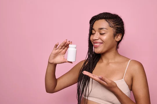 Girl holding pills.