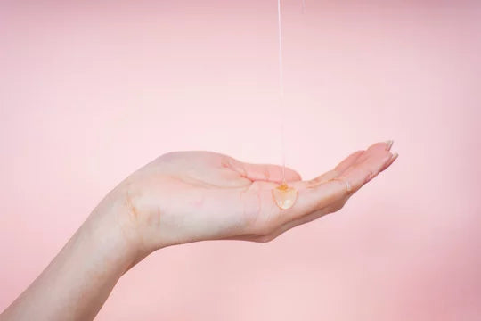 Woman pouring oil in hand