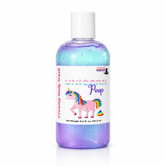 A bottle of 'Unicorn Poop' creamy body wash featuring a white cap and a white label with a colorful pink unicorn illustration and rainbow accents, set against a plain white background.