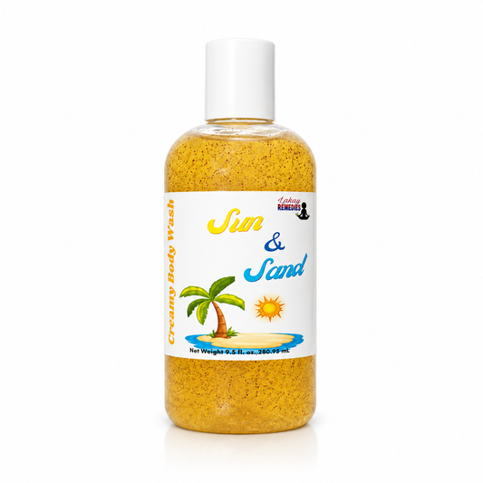 A bottle of 'Sun & Sand' creamy body wash by LakayRemedies, filled with a golden-yellow granular scrub and topped with a white cap, set against a plain white background.