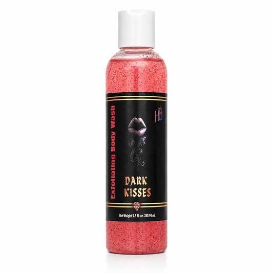 A bottle of exfoliating body wash with pink-red liquid inside, featuring a black label with gold and white text that reads 'Dark Kisses' and a white cap, set against a plain white background.