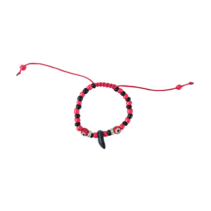 Beaded bracelet with red and black beads on a white background