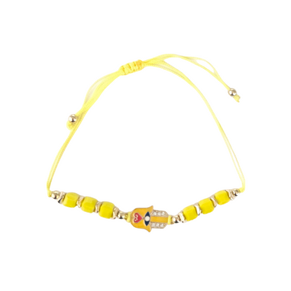 Yellow beaded bracelet with a hamsa hand charm on a white background