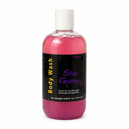 A bottle of Star Gazing Body Wash with pink liquid, a black label, and a white cap, shown on a white background.