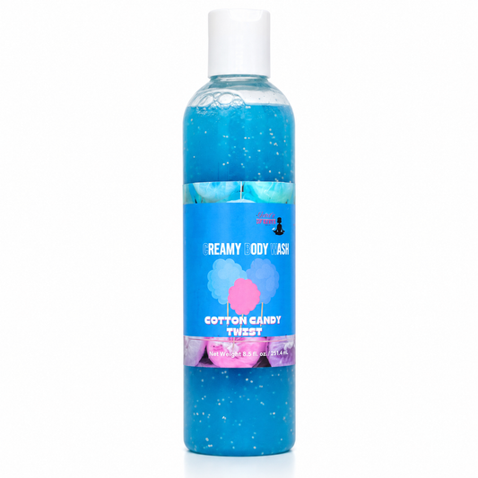 A bottle of body wash with blue gel inside, featuring a white cap and a blue label with pink and white text that reads 'Creamy Body Wash' and 'Cotton Candy Twist'.