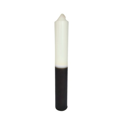 candle with white top and black bottom on a white background