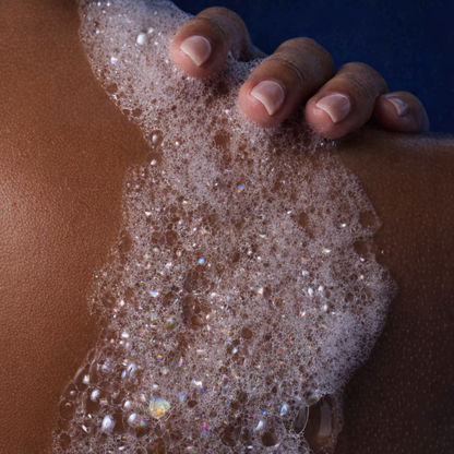 Hand applying soap to skin with a close-up view of the foam.