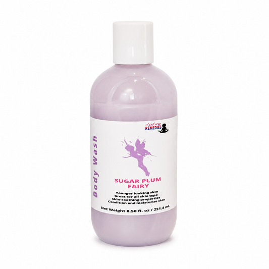 A bottle of Sugar Plum Fairy body wash by Sally Remedy, featuring a translucent lavender bottle, white cap, and a white label with purple and pink text and graphics.