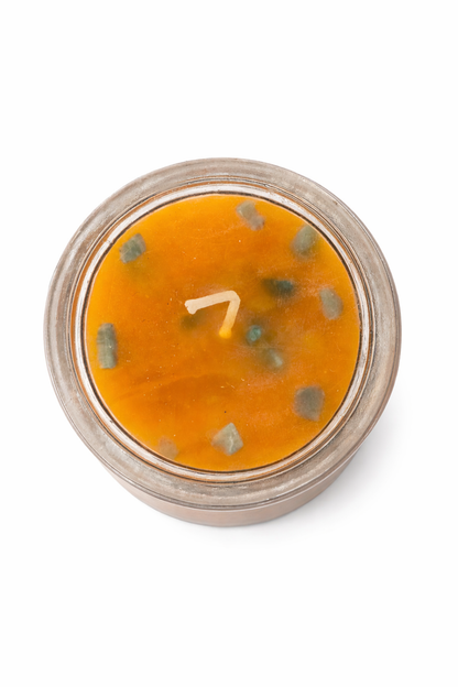 Moldy orange substance in a jar on a white background