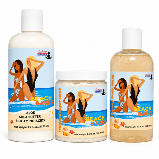 Three skincare products from Lakay Remedies Beach Babes line: a large bottle of Aloe Shea Butter Silk Amino Acids, a jar of Whipped Body Scrub, and a bottle of Body Wash, all featuring matching tropical beach-themed labels on a white background.