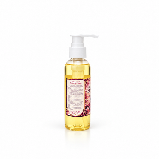A bottle of Her Beauty Factory Sugar Plum Fairy Body Oil with a white pump dispenser, featuring a pink and purple label with illustrations, set against a plain white background.