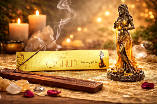 Oshun incense sticks with a statue and candles on a decorative background