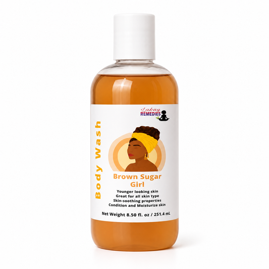 A bottle of Lakay Remedies Brown Sugar Girl body wash, filled with amber-colored liquid and featuring a white cap and label with an illustration of a woman.