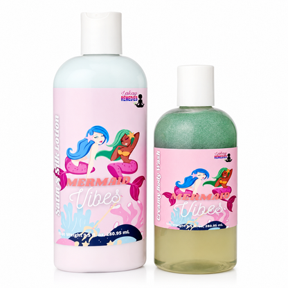 Two cosmetic bottles with white caps on a white background. The larger bottle is a pale minty pink body wash labeled 'Mermaid Vibes' by Lakay Remedies, and the smaller bottle is a translucent greenish-yellow body wash with a matching pink label.