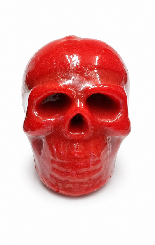 Red skull-shaped candle on a white background