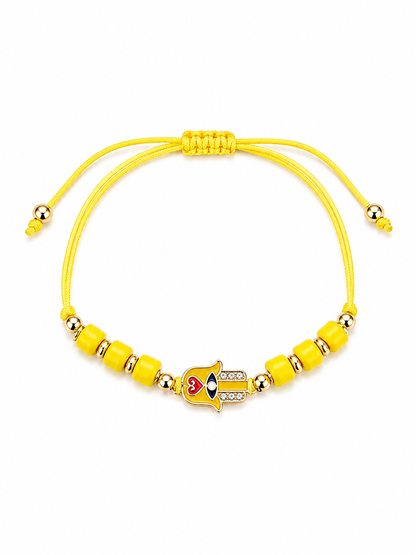 Yellow beaded bracelet with a heart-shaped on Hamsa Hand on a white background