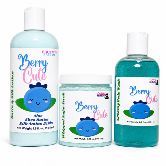 Three bath and body products from Lakay Remedies 'Berry Cute' scent: a large bottle of Aloe Shea Butter Silk Amino Acids satin & silk lotion, a jar of whipped sugar scrub, and a bottle of creamy body wash, all featuring a blue cartoon character on white labels.