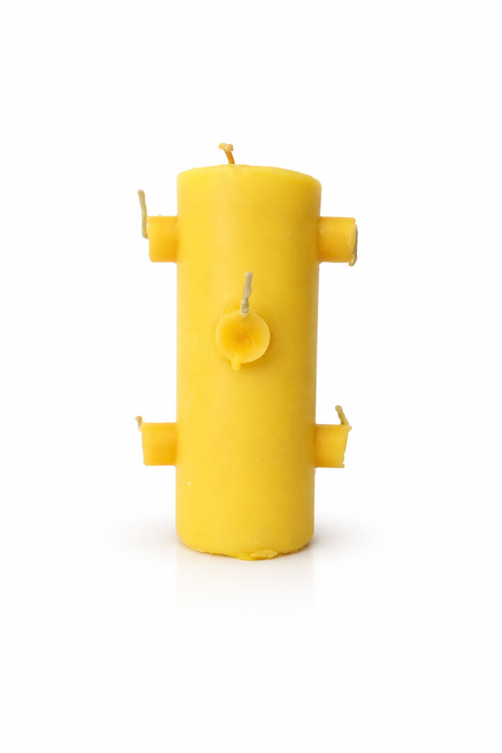 Yellow candle shaped like a fire hydrant on a white background