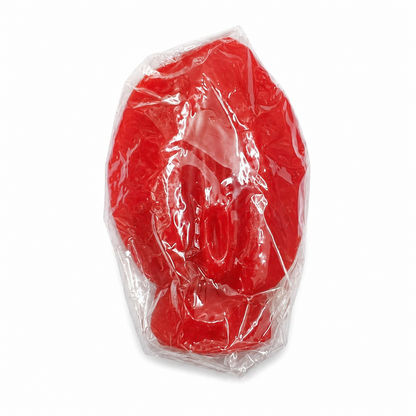 Red vagina candle in clear plastic packaging on a white background