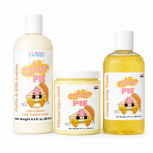 Three cosmetic products from Her Beauty Factory against a white background: a large bottle of Shea Butter Silk Amino acids on the left, a jar of Whipped Sugar Scrub in the center, and a bottle of Creamy Body Wash on the right. All feature a 'Cute Pie' character label.