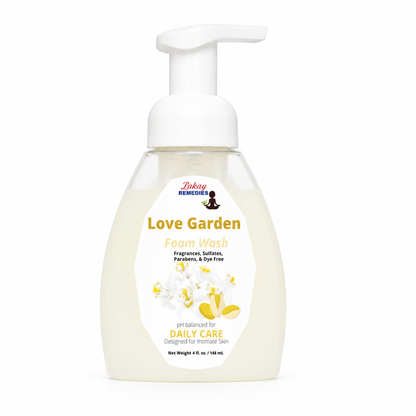 A bottle of Love Garden Foam Wash with a white pump dispenser and a white label featuring yellow and red text, set against a plain white background.
