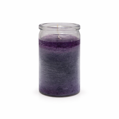 Purple candle in a glass jar on a white background