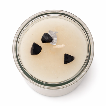 Candle in a glass jar with decorative elements on a white background