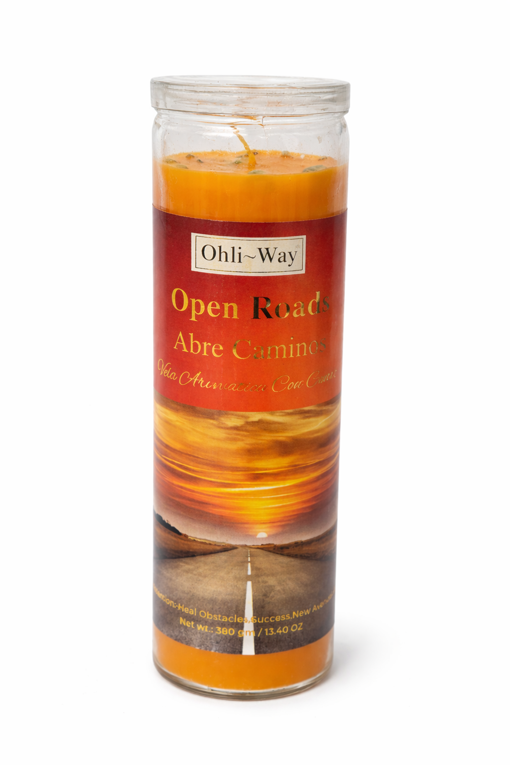 Candle with a label reading 'Open Roads Abre Caminos' on a white background