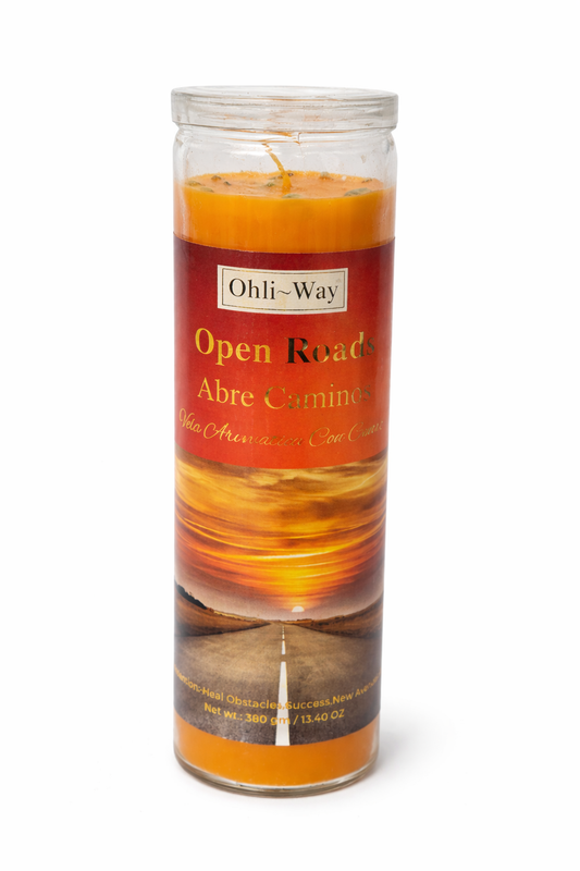 Candle with a label reading 'Open Roads Abre Caminos' on a white background