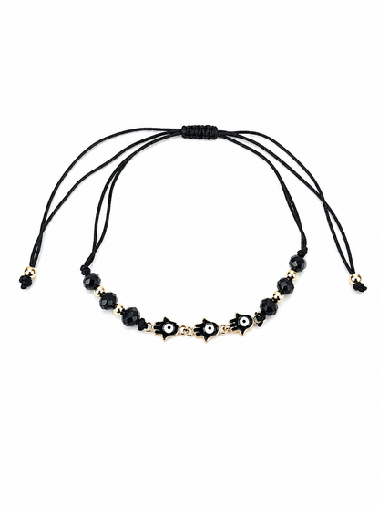 Black cord bracelet with black beads and gold accents on a white background