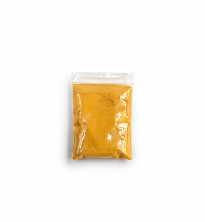 Clear plastic bag with yellow powder on a white background
