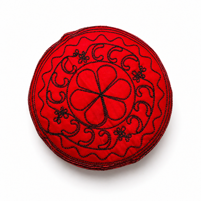 Red hat with black embroidery on a white background