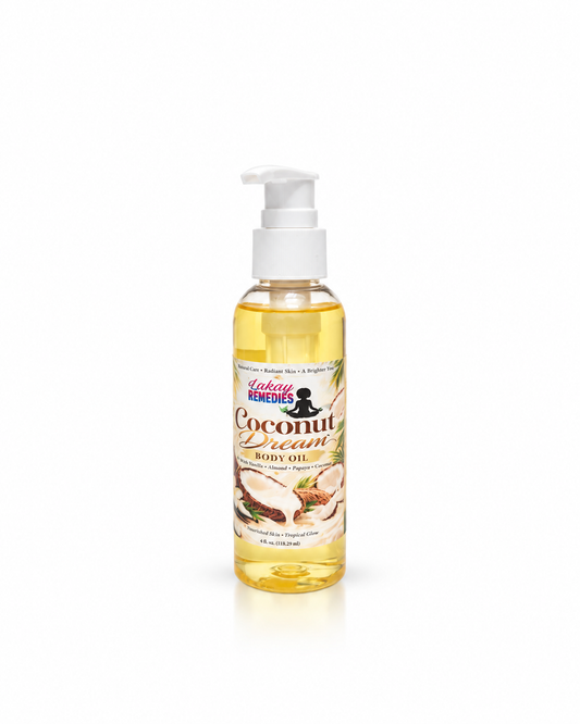A bottle of Lakay Remedies Coconut Cream Body Oil with a white pump dispenser, containing a golden yellow oil, set against a plain white background.