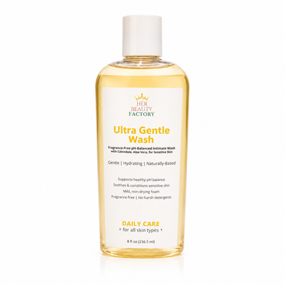 A bottle of Her Beauty Factory Ultra Gentle Wash intimate cleanser, featuring a clear plastic bottle filled with pale yellow liquid and a white cap, set against a clean white background.