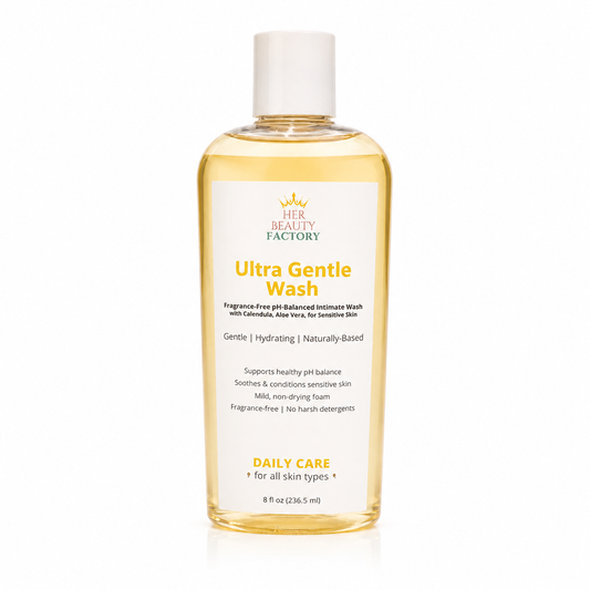 A bottle of Her Beauty Factory Ultra Gentle Wash intimate cleanser, featuring a clear plastic bottle filled with pale yellow liquid and a white cap, set against a clean white background.